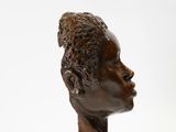 sculpture of a head of a man on a white surface