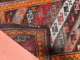 a close up view of a rug with a pink background