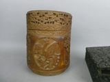 a wooden box with carvings on it next to a rock