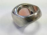 silver ring with a pink stone in the middle of it
