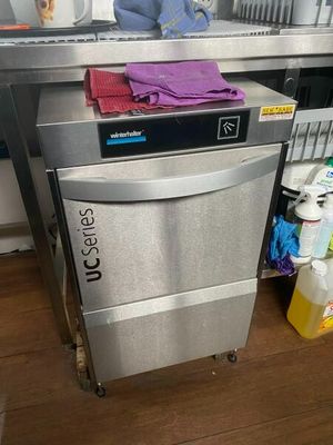 a silver dishwasher sitting in a kitchen next to a counter