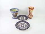 three different types of vases and plates on the table
