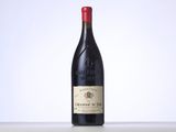 the bottle of red wine is sitting on the table