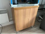 a microwave oven sitting on top of a wooden cabinet