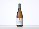 the bottle of white wine is sitting on the table