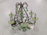 a green chandelier that is on display in a store