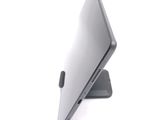 a laptop that is sitting on a stand on a white surface