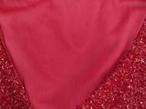 a close up of a red dress with a label on it