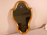 a mirror that is sitting on the wall next to a bed