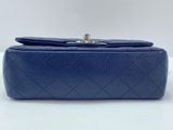 a blue leather clutch bag with a gold clasp
