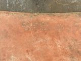 a close up of a rusted piece of metal with writing on it