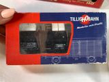 a person holding a box with a pair of train cars in it