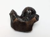 statue of a man sitting on a chair with his arms crossed