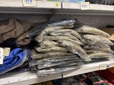 a pile of bananas on a shelf in a store