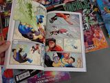 a person holding a comic book open on a table