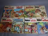 several comics are lined up in a row on a table