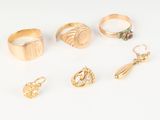 six pairs of gold rings and a pair of earrings