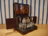 a wooden table with a glass set on top of it