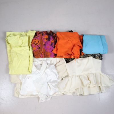 a lot of clothes that are on a white surface