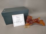 a small figurine of a bear sitting next to a box