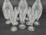 six clear glass wine glasses sitting on top of a black table