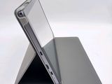 a close up of a laptop on a stand on a white surface