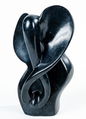 une sculpture noire représentant un objet en forme de cœur sur fond blanc
