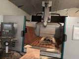 a machine that is working on a piece of wood