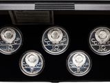 six silver coins in a black display case with a picture of a man