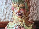 a ceramic figurine of a man with a hat and scarf