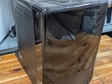 a small refrigerator sitting on a wooden table in a kitchen