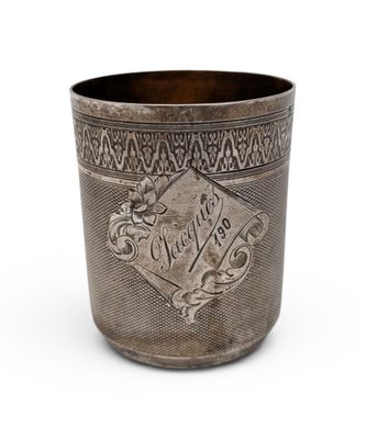 a silver cup with a design on the side of it