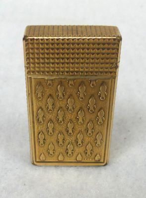 gold plated box with ornate design on it on a white surface