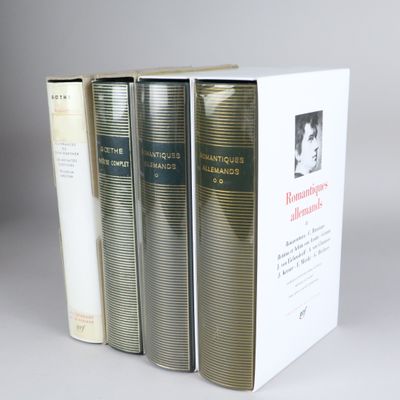 three books are stacked on top of each other on a table