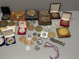 a lot of medals and medals on the table