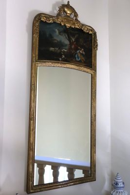 a mirror hanging on the wall in the corner of a room