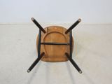 an image of a wooden chair with four black legs