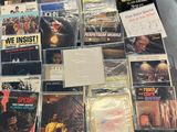 a lot of music cds and cds on the table