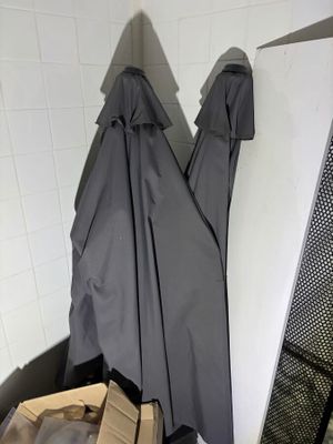two umbrellas hanging on the wall next to a pile of boxes