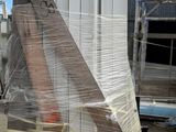 a pile of wood and plastic wrapped around a building