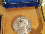 a silver coin with a picture of a man on it