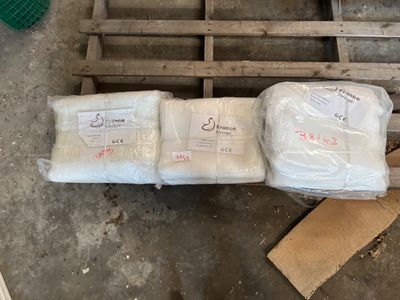 several bags of food sitting on top of a pallet in a warehouse