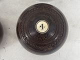 four wooden bowls with numbers on them sitting on a white surface
