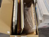 a cardboard box full of laptops and other items in it