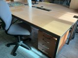 a desk with a chair and a computer on it