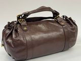 a brown leather handbag on a white background