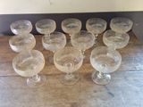 a lot of empty wine glasses sitting on a wooden table
