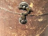 an old wooden box with a metal latch on it