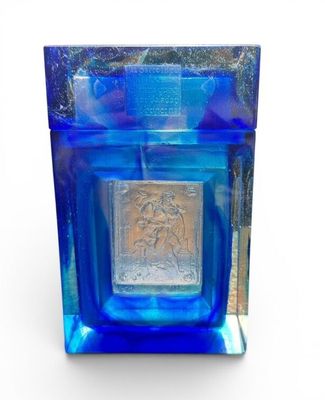 a blue glass container with a silver square in it