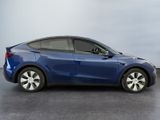 the blue tesla model s is parked in a parking lot